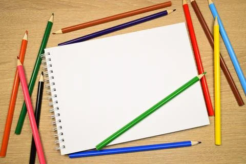 Blank notebook with colored pencils Stock Photos
