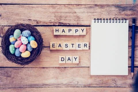 Blank notebook, Colorful easter egg in the nest and wood text for Happy Eas.. Stock Photos