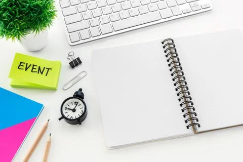 Blank notebook with on computer desk with pencil and clock for event planning Stock Photos