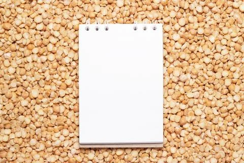 Blank notebook on dry peas background Stock Photos