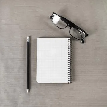 Blank notebook, glasses, pencil Stock Photos