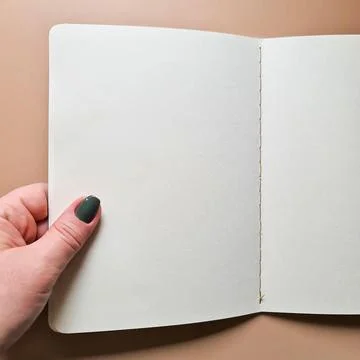 Blank notebook in hand Stock Photos