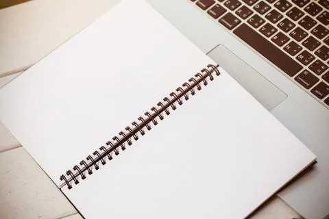 Blank notebook on laptop workspace Fotos Stock