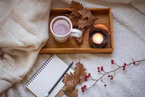 Blank notebook with mug of coffee in bed Stock Photos