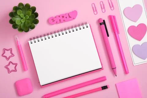 Blank notebook page for text in frame of yellow stationery set on pink back Stock Photos