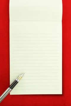 Blank notebook on red background Stock Photos