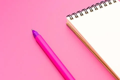 Blank notebook with spiral for the application of labels and pen on pink back Stock Photos
