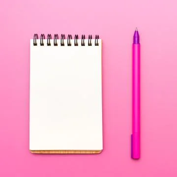 Blank notebook with spiral for the application of labels and pen on pink back Stock Photos