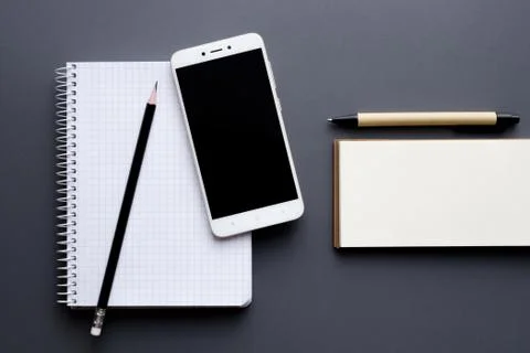 Blank notepad and notebook with smartphone, pencil and pen Foto stock