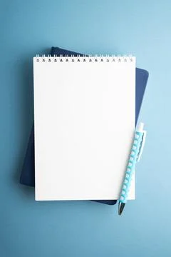 Blank Notepad and Pen Lay Flat on Textured Blue Background Ready for Design 스톡 사진