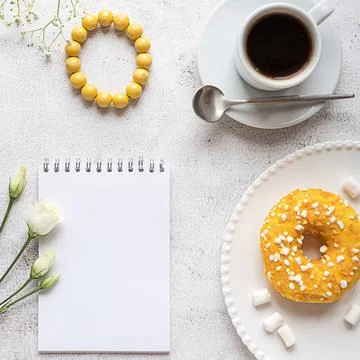 A blank notepad with breakfast setting and ladies accessories. Copy space. Stock Photos