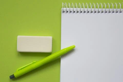 Blank notepad with green pen on light green background Stock Photos