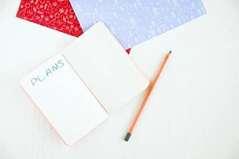 Blank notepad for making plans, pencil and decorated Christmas papers Stock Photos