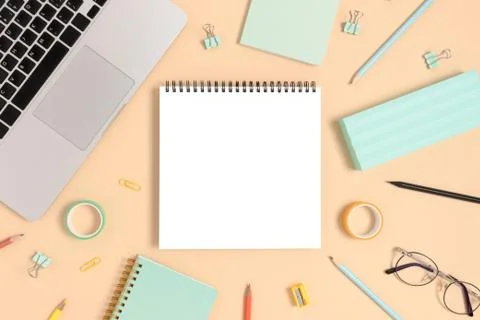 Blank notepad mockup. Top view of laptop and stationery. Stock Photos