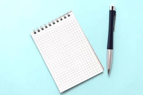 Blank notepad with pen on turquoise background close up Stock Photos