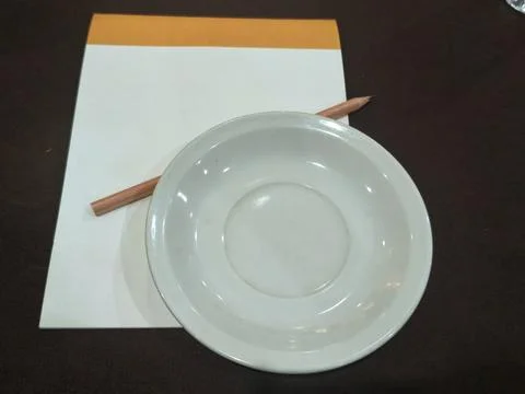 Blank Notepad with Pencil and Empty White Saucer Fotos de archivo