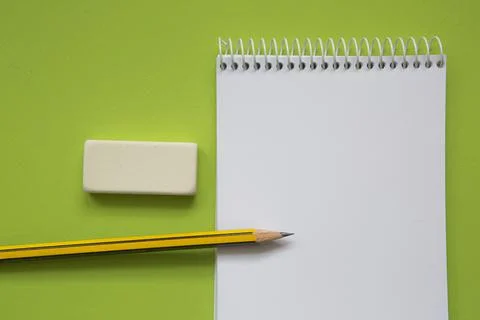 Blank notepad with pencil on light green background Stock Photos