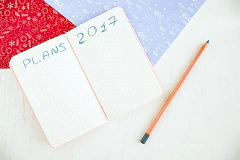 Blank notepad for planning 2017, pencil and decorated Christmas papers Stock Photos