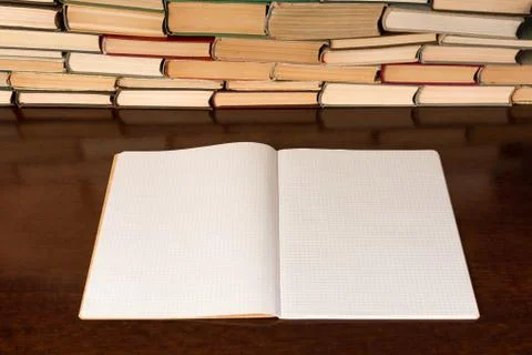 Blank notepad on the table with books background Stock Photos