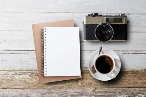 Blank notepad,old camera and coffee cup on white wooden Foto stock