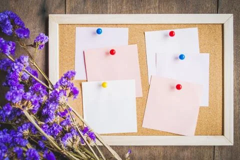 Blank notes on the cork board with dry flower bouquet,wooden background Stock Photos