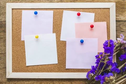 Blank notes on the cork board with dry flower bouquet,wooden background. Stock Photos
