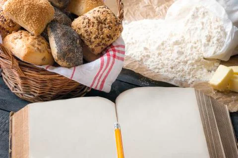 Blank open book and bread buns Stock Photos