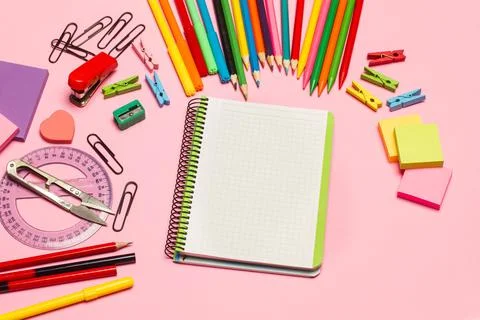 Blank open graph paper notebook and school utensils on a pink background Foto stock