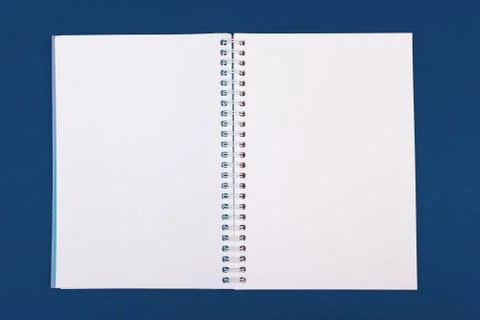 Blank open notebook on classic blue background top view Stock Photos