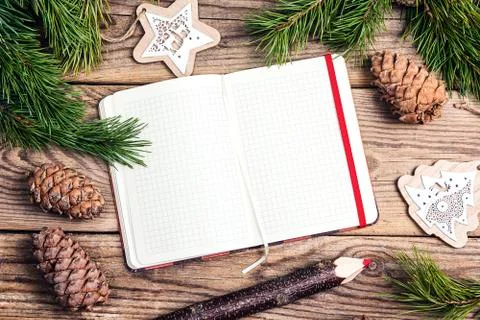 Blank open notebook, pine branches, cedar cones and decorations on old  woode Stock Photos