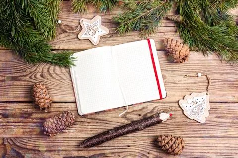 Blank open notebook, pine branches, cedar cones and decorations on old  woode Stock Photos