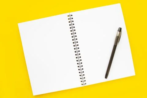 Blank open notepad on yellow background top view Stock Photos