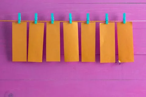 Blank orange note pad sheets hanging from string Stock Photos