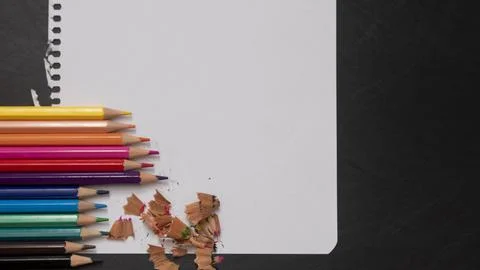 Blank page of a notebook as a mock up next to pencils of different colors on  Stock Photos