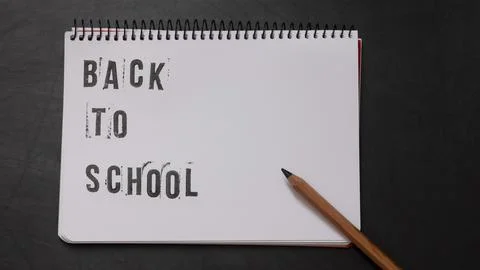 Blank page of a notebook with the phrase "Back To School" written in English  Stock Photos