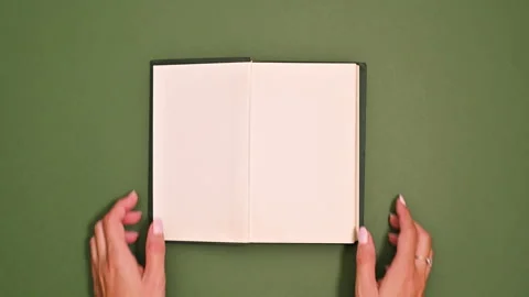 Two hands opening a book with blank page, Stock Video