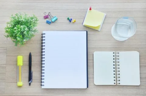 Blank paper and office tools on the wood table - top view Stock Photos