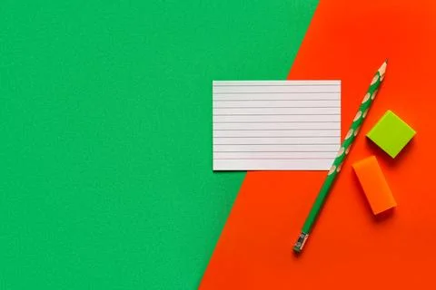 Blank paper card with different rubber erasers and pencil on color background Stock Photos