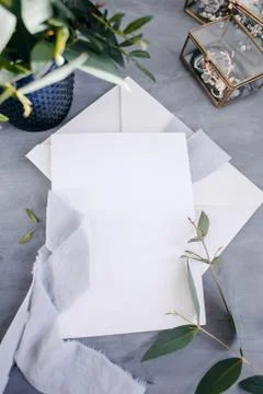 Blank paper copy space. Frame with flowers. Silk ribbon. Gray background. Sim Stock Photos