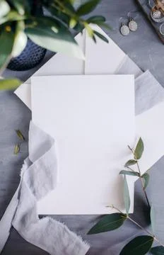 Blank paper copy space. Frame with flowers. Silk ribbon. Gray background. Sim Stock Photos
