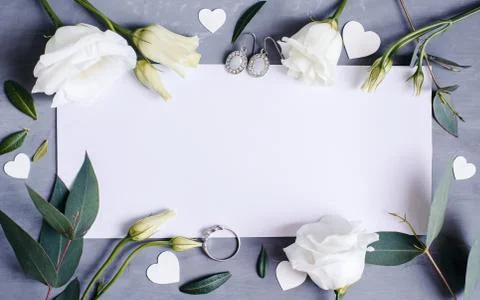 Blank paper copy space. Frame with flowers. Silk ribbon. Gray background. Sim Stock Photos