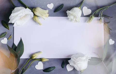 Blank paper copy space. Frame with flowers. Silk ribbon. Gray background. S.. Stock Photos