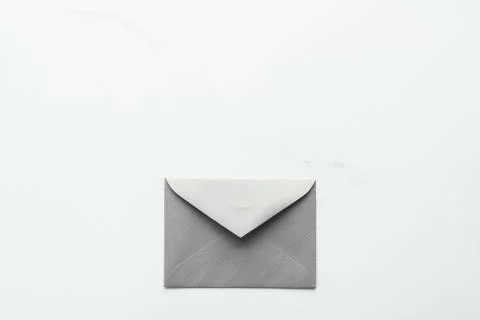 Blank paper envelopes on marble flatlay background, holiday mail letter or po Stock Photos