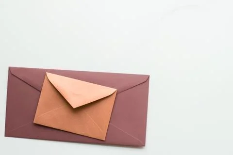 Blank paper envelopes on marble flatlay background, holiday mail letter or po Stock Photos