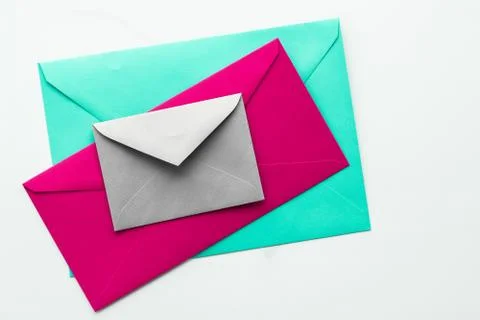 Blank paper envelopes on marble flatlay background, holiday mail letter or po Stock Photos