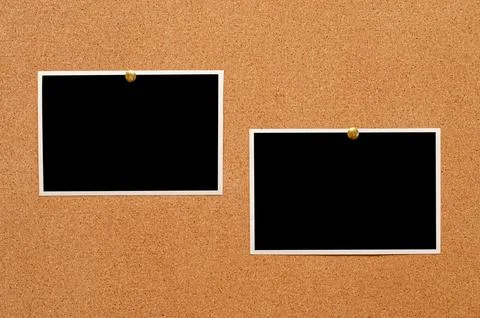 Blank paper notes and an empty photo are pinned to a cork board. The concep.. Stock Photos