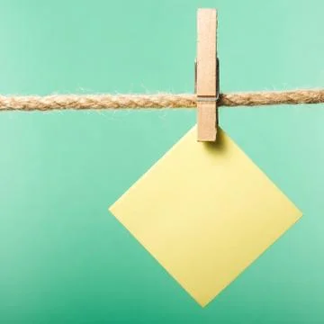 Blank paper notes hanging on rope with clothes pins, copy space Stock Photos