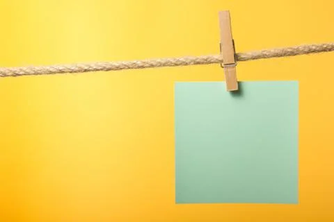 Blank paper notes hanging on rope with clothes pins, copy space Stock Photos