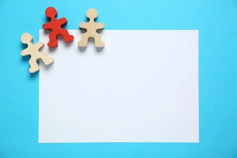 Blank paper sheet and human figures on light blue background, flat lay. Spa.. Stock Photos