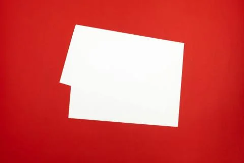 Blank paper sheet on bright red background.  Stock Photos
